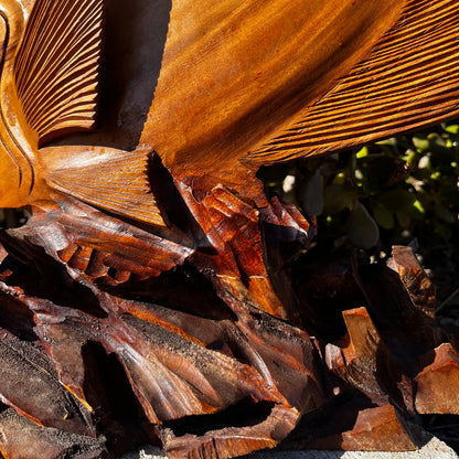 A detailed view of the hand-carved wooden coral reef base, highlighting the intricate textures and craftsmanship. Made from mahogany wood, set against a natural background.