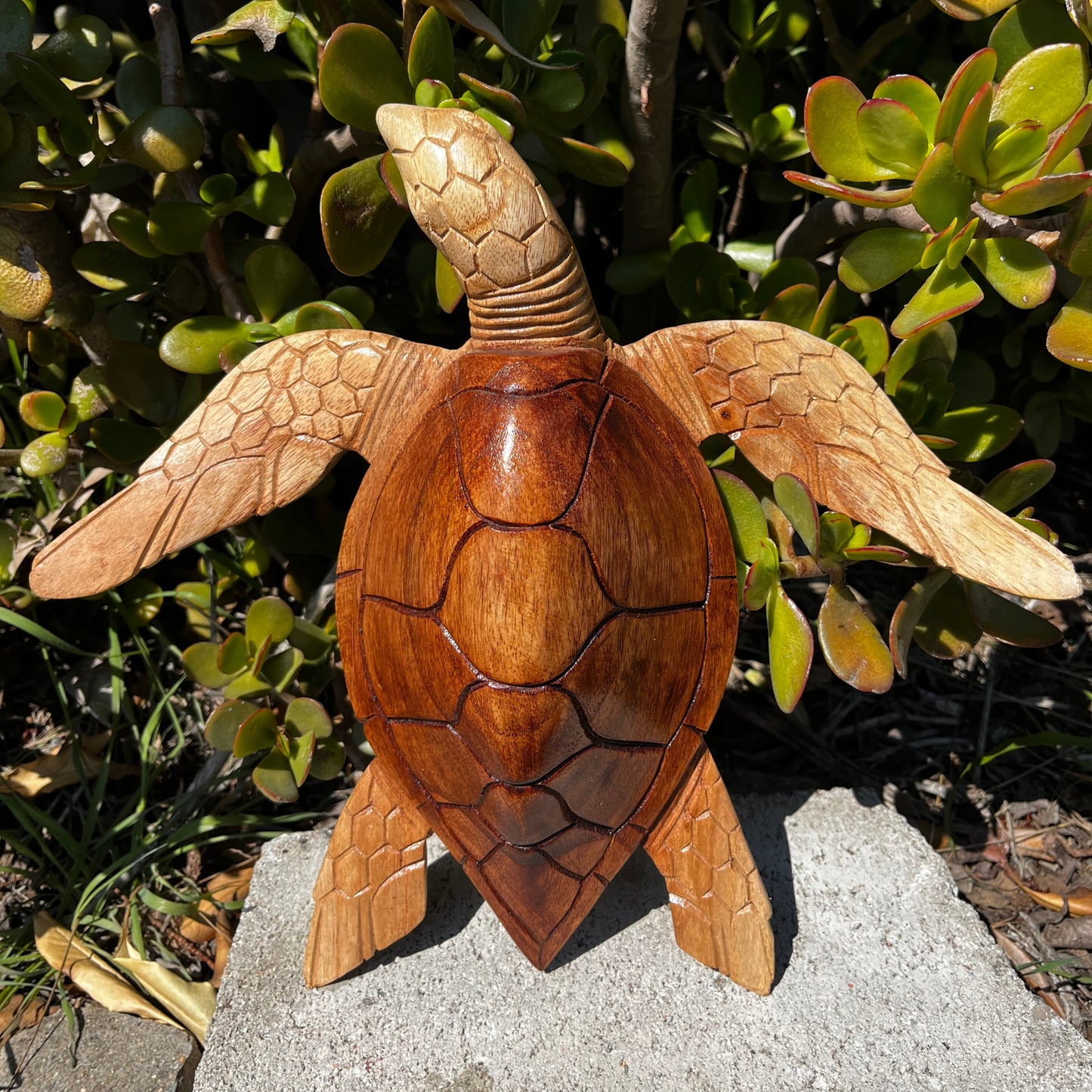 Rustic hand-carved sea turtle sculpture made from natural teak wood. Flat-back design perfect for lying flat like it's on the beach. Adds coastal charm to any space.