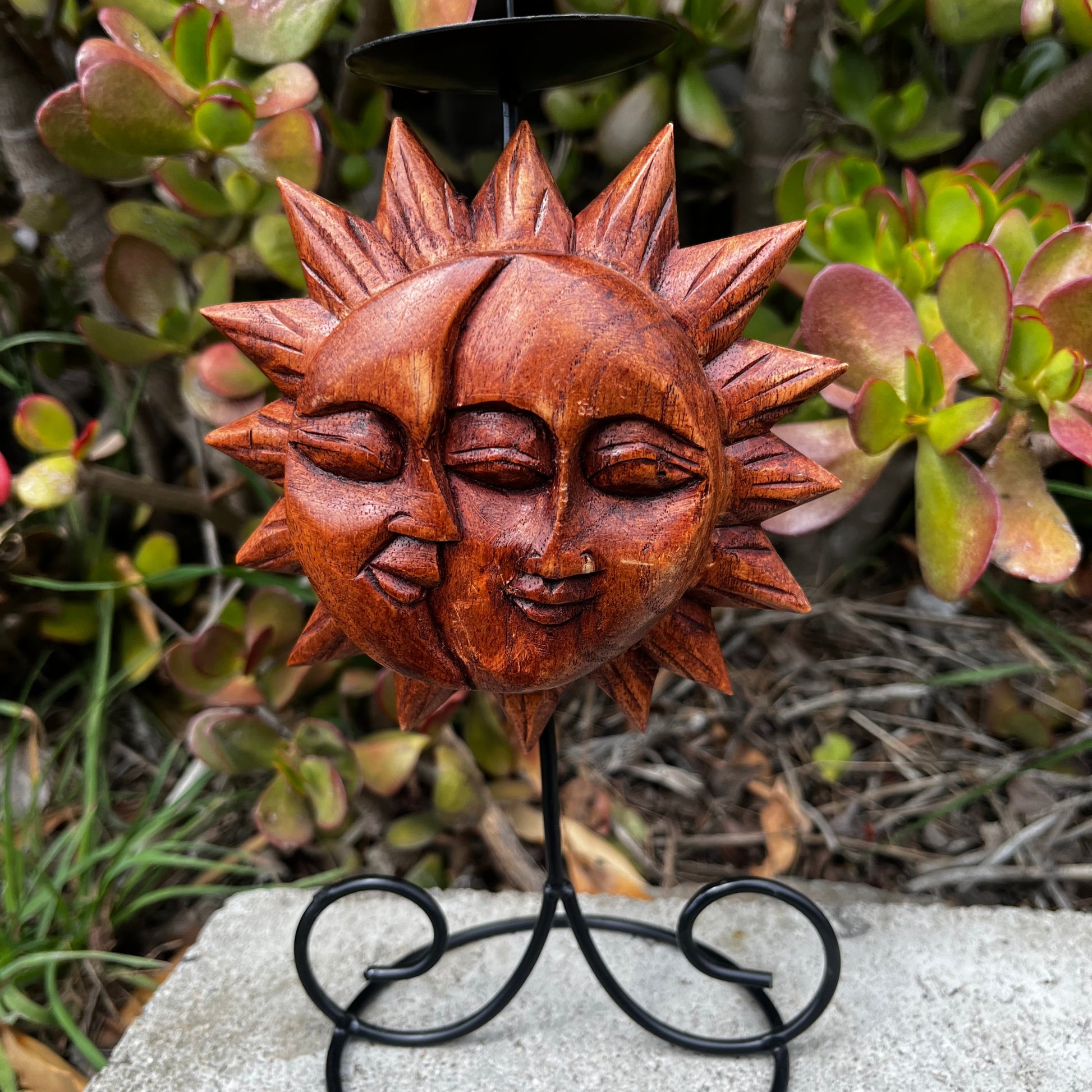 Sun and moon home accent candle holder, handmade with intricate craftsmanship, showcasing a natural wood design, displayed on a nature-inspired background. 